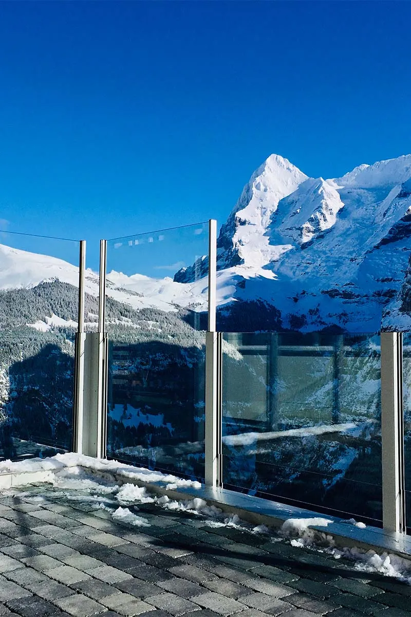 Alpine terrace: Wind held back, peaks in view
