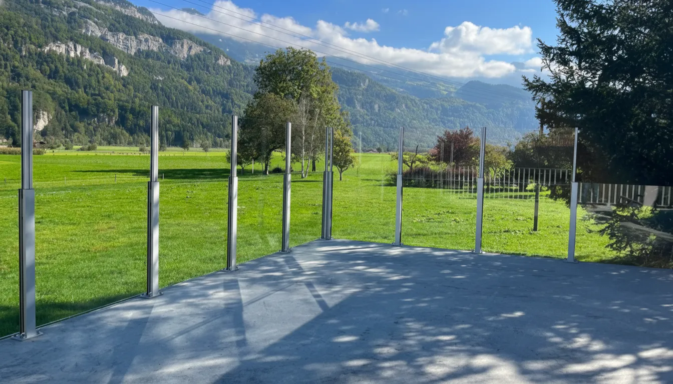 SlideGlass posts and glass along a terrace, with the mountains of the Bernese Oberland behind.